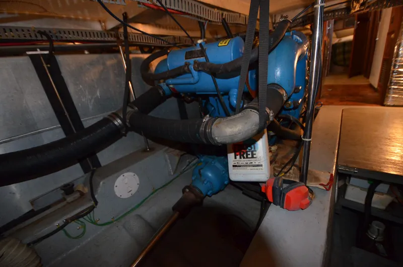 Slide: The Image of Engine room of 1986 Carver Cockpit 4227 MY with visible blue engine components. - 20