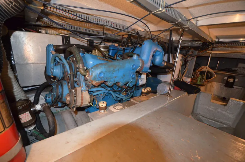 Slide: The Image of Engine room of 1986 Carver Cockpit 4227 MY with blue machinery and wiring. - 21