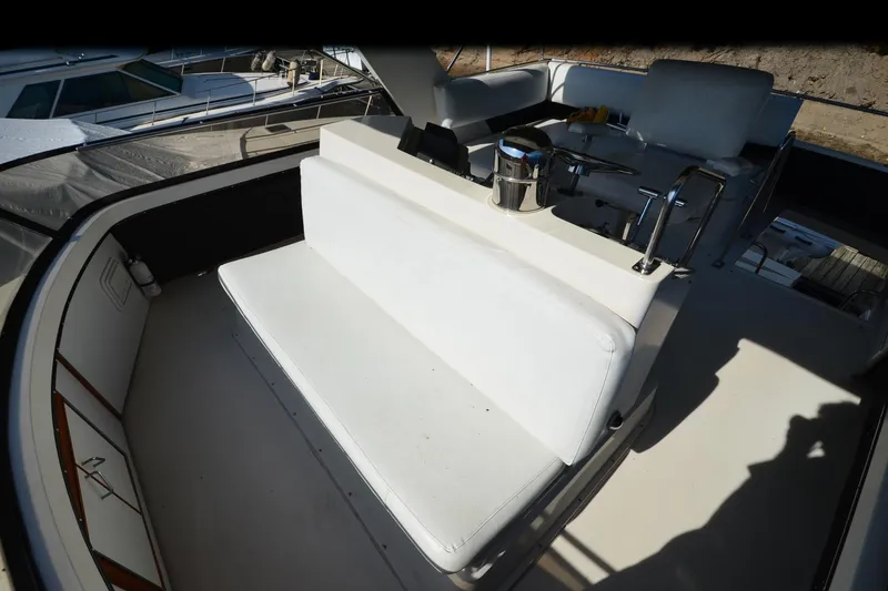 Slide: The Image of 1986 Carver Cockpit 4227 MY boat interior with white seating and control area. - 25