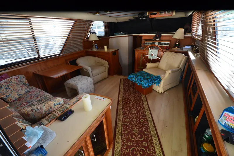 Slide: The Image of Interior of 1986 Carver Cockpit 4227 MY yacht with cozy seating and wooden accents. - 27