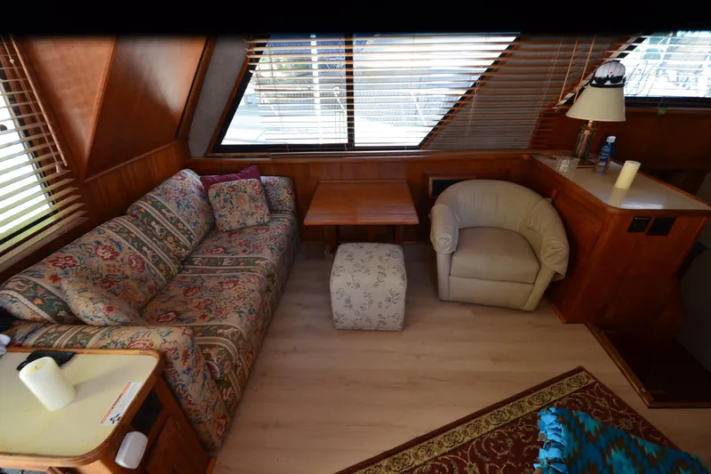 Slide: The Image of Interior of 1986 Carver Cockpit 4227 MY with floral sofa, armchair, and wooden accents. - 29