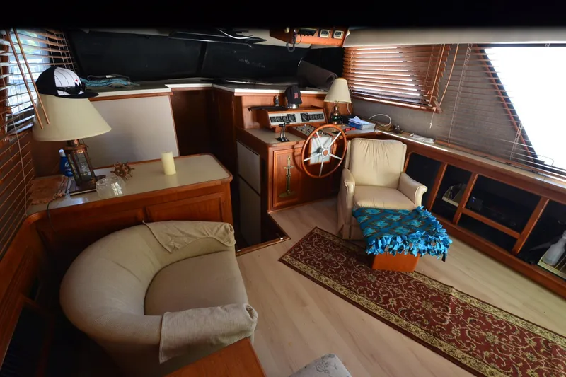 Slide: The Image of 1986 Carver Cockpit 4227 MY interior with cozy seating and wooden helm. - 30