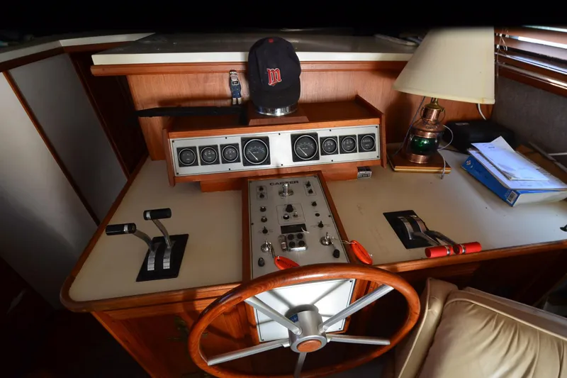 Slide: The Image of 1986 Carver Cockpit 4227 MY boat helm with controls, gauges, and steering wheel. - 31