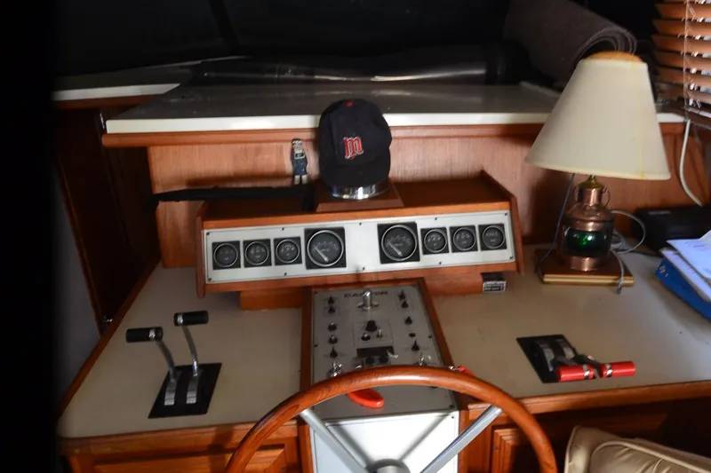 Slide: The Image of 1986 Carver Cockpit 4227 MY helm with gauges, controls, and a lamp. - 32