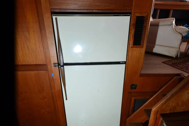 Slide: The Image of 1986 Carver Cockpit 4227 MY interior with vintage refrigerator and wooden cabinetry. - 35