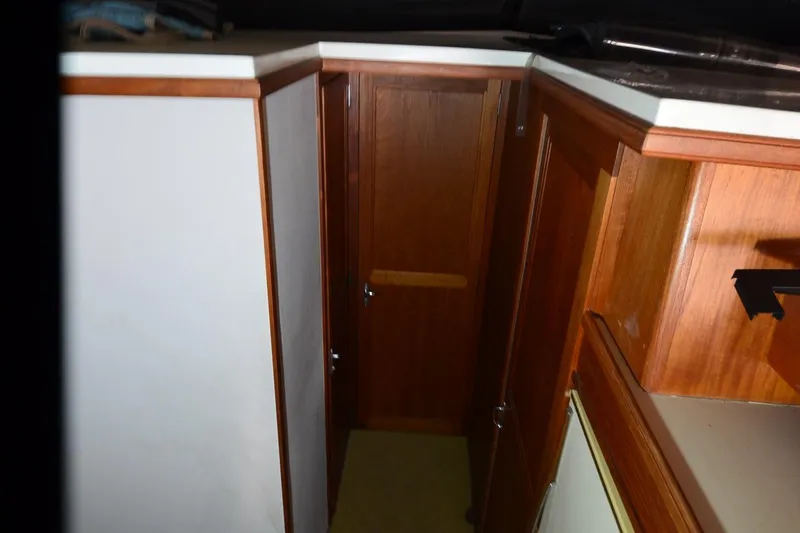 Slide: The Image of 1986 Carver Cockpit 4227 MY interior with wooden cabinetry and door. - 36