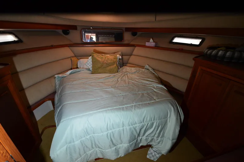 Slide: The Image of 1986 Carver Cockpit 4227 MY cabin interior with cozy bed and wooden cabinetry. - 40