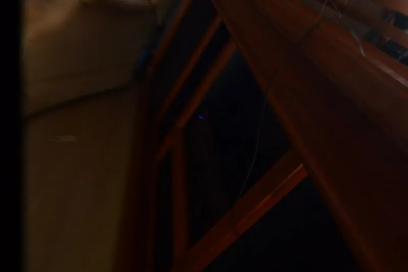 Slide: The Image of 1986 Carver Cockpit 4227 MY interior with wooden paneling and dim lighting. - 45