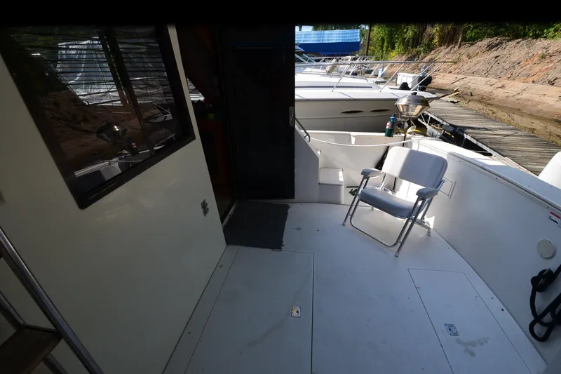 Slide: The Image of 1986 Carver Cockpit 4227 MY boat interior with chair and dock view. - 46