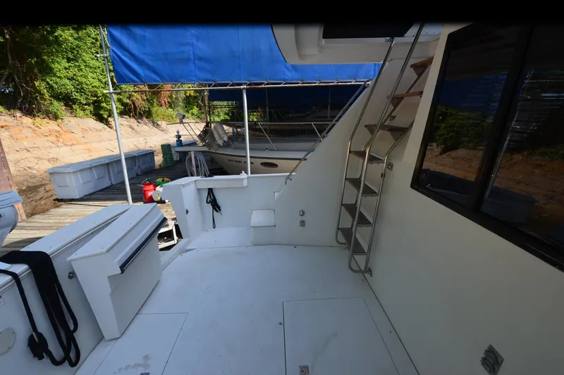 Slide: The Image of 1986 Carver Cockpit 4227 MY boat interior with dockside view and blue canopy. - 48