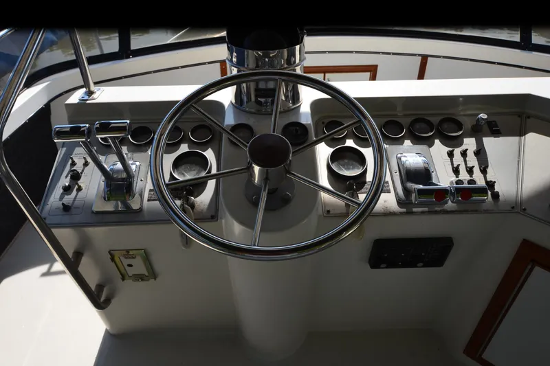 Slide: The Image of 1986 Carver Cockpit 4227 MY boat helm with steering wheel and control panel. - 49