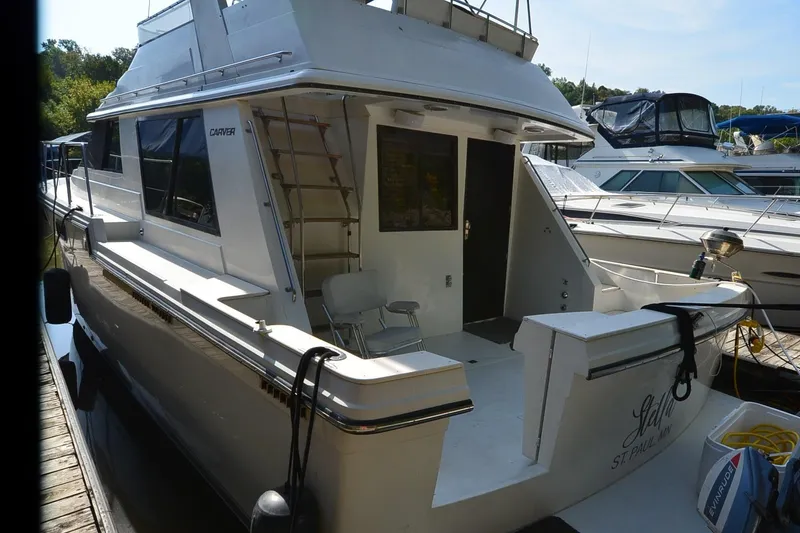 Slide: The Image of 1986 Carver Cockpit 4227 MY yacht docked at marina, rear view. - 5