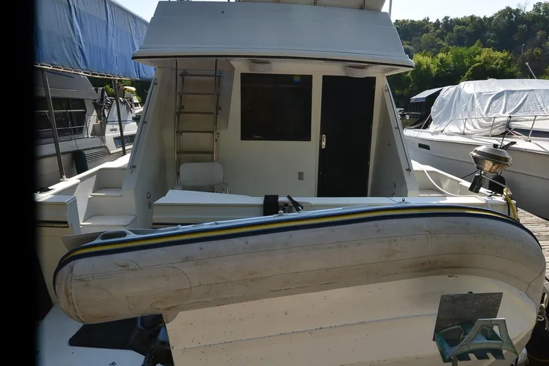 Slide: The Image of 1986 Carver Cockpit 4227 MY yacht with inflatable boat on deck. - 53