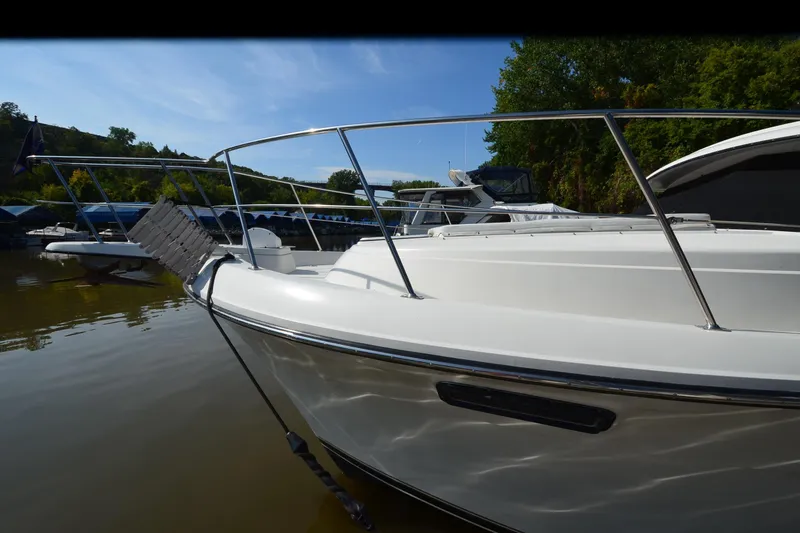 Slide: The Image of 1986 Carver Cockpit 4227 MY yacht docked on calm water, surrounded by lush greenery. - 57