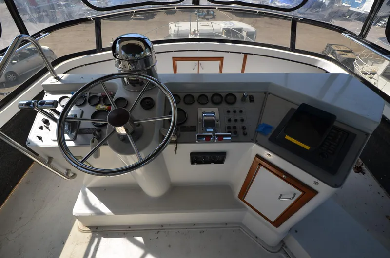 Slide: The Image of 1986 Carver Cockpit 4227 MY helm with steering wheel and control panel. - 6
