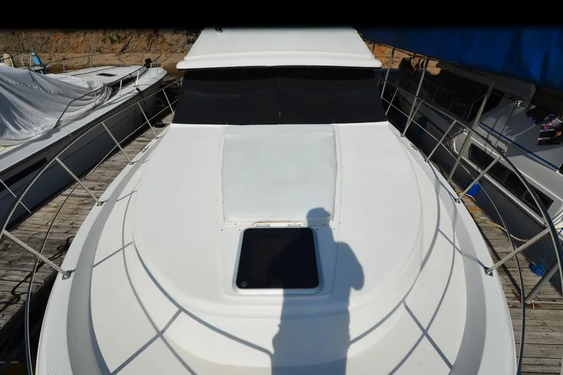 Slide: The Image of 1986 Carver Cockpit 4227 MY yacht docked, top view with shadow on deck. - 60