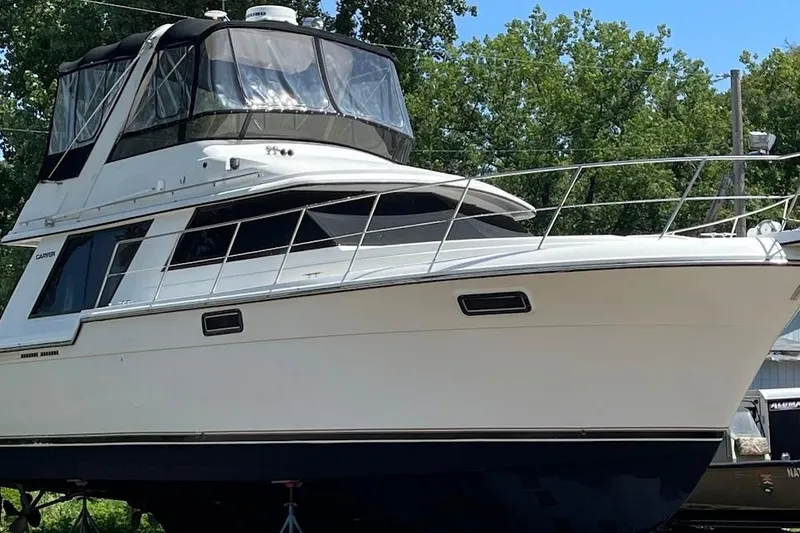 Slide: The Image of 1986 Carver 4227 Cockpit Motor Yacht on land, surrounded by trees. - 63