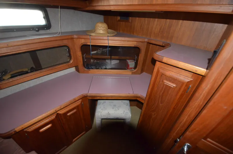 Slide: The Image of 1986 Carver Cockpit 4227 MY interior with wood cabinetry and seating area. - 8