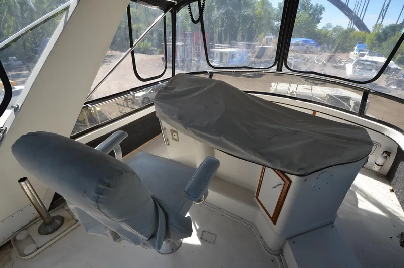 Slide: The Image of 1986 Carver Cockpit 4227 MY interior with covered controls and captain's chair. - 9