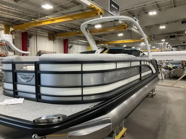 Slide: The Image of 2023 Bennington 25 RFBWA Tritoon boat in a factory setting. - 3