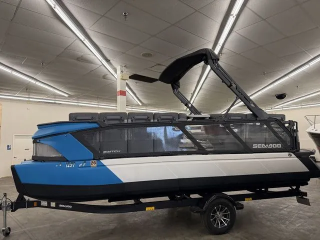 Slide: The Image of 2023 Sea-Doo Switch Cruise 21 pontoon boat in a showroom. - 4