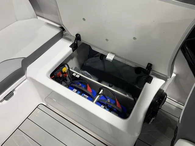 Slide: The Image of 2023 Yamaha Boats 252XE battery compartment with dual batteries and wiring. - 10
