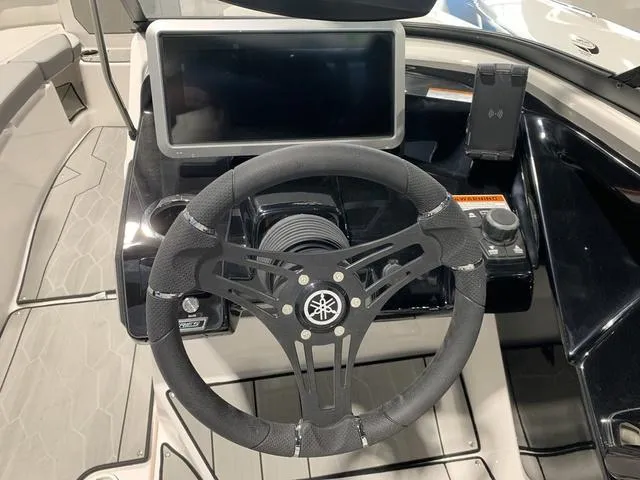 Slide: The Image of 2023 Yamaha Boats 252XE dashboard with steering wheel and touchscreen display. - 16