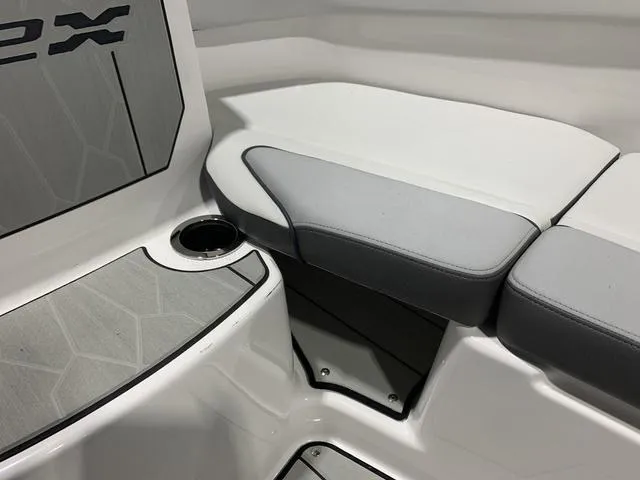 Slide: The Image of 2023 Yamaha Boats 252XE interior seating with cup holder and sleek design. - 23