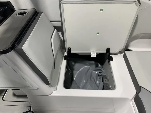 Slide: The Image of 2023 Yamaha Boats 252XE storage compartment with open lid, showcasing interior space. - 8