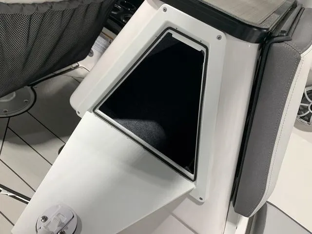 Slide: The Image of 2023 Yamaha Boats 252XE interior storage compartment with sleek design and modern features. - 9
