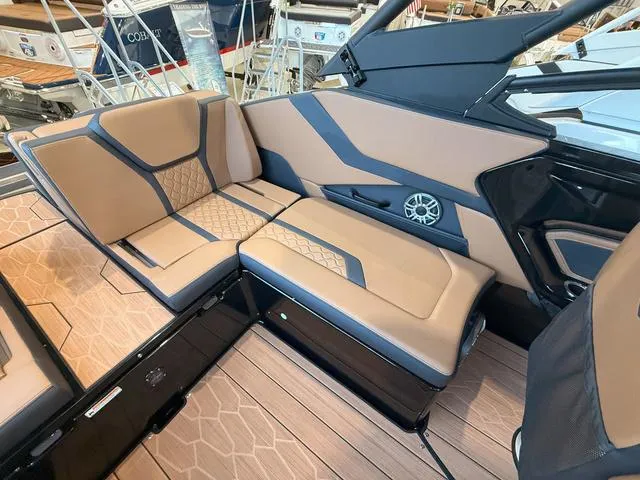 Slide: The Image of 2025 Yamaha Boats 255XD interior with tan and black seating, modern design, and speaker system. - 7