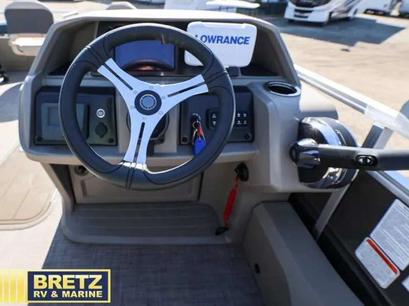 Slide: The Image of 2024 Fishin' Barge 22 XP3 steering console with Lowrance display and controls. - 13