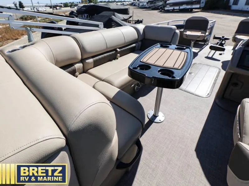 Slide: The Image of 2024 Fishin' Barge 22 XP3 interior with beige seating and table, Bretz RV & Marine. - 15