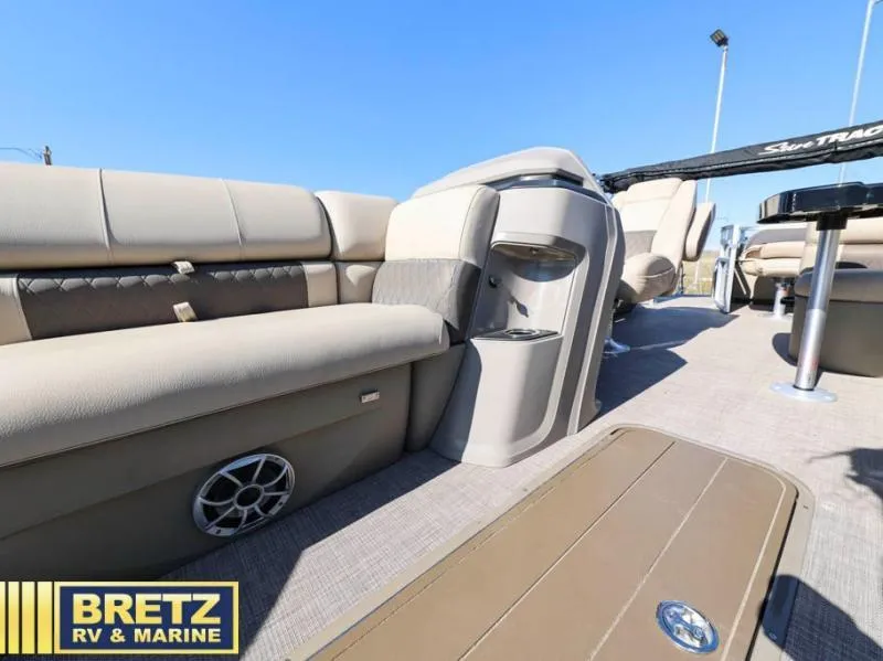 Slide: The Image of 2024 Fishin' Barge 22 XP3 interior with beige seating and modern amenities. - 19