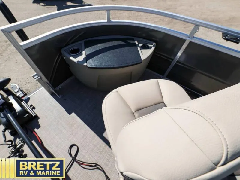 Slide: The Image of 2024 Fishin' Barge 22 XP3 boat interior with beige seating and storage compartment. - 20
