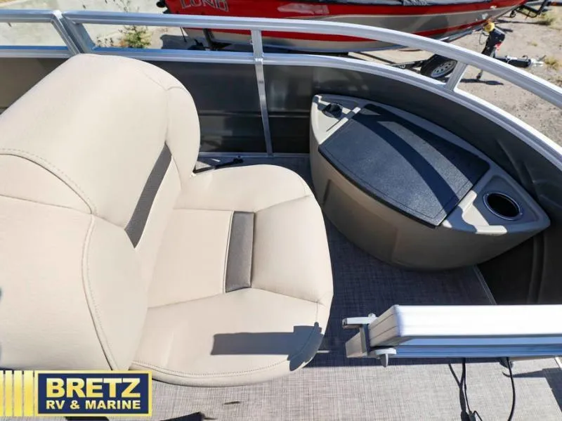 Slide: The Image of 2024 Fishin' Barge 22 XP3 interior seating with storage and cup holder. - 21