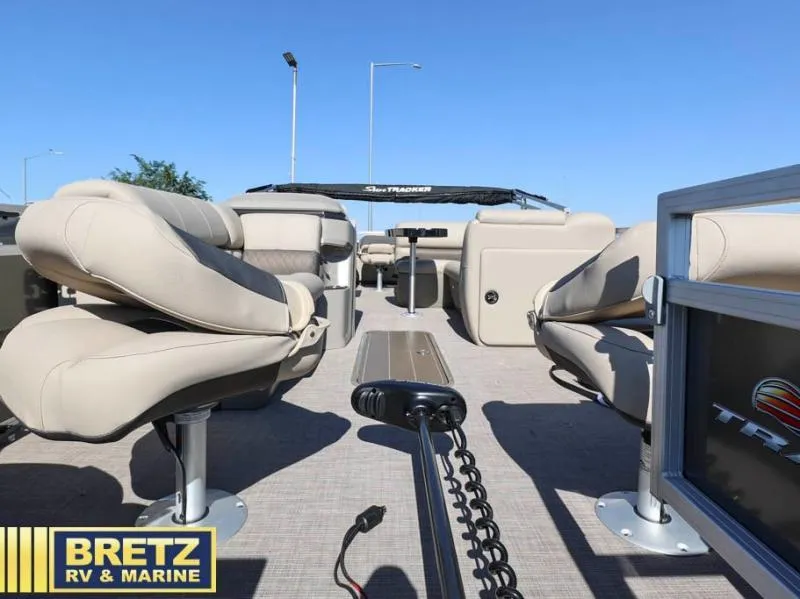 Slide: The Image of 2024 Fishin' Barge 22 XP3 interior with beige seating, showcased by Bretz RV & Marine. - 8