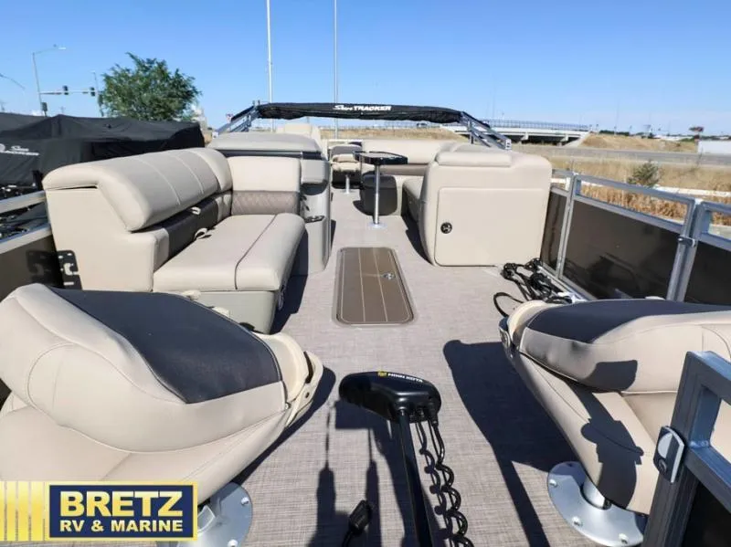 Slide: The Image of 2024 Fishin' Barge 22 XP3 pontoon boat interior with seating and steering console. - 9