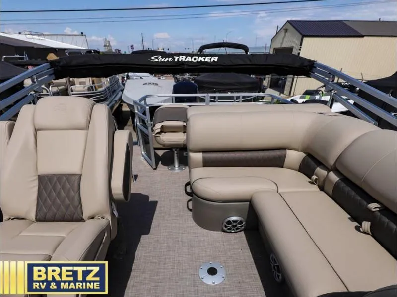 Slide: The Image of 2024 Sportfish 22 DLX pontoon boat interior with beige seating at Bretz RV & Marine. - 12