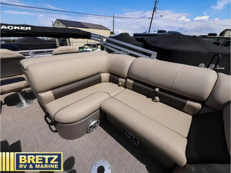 Slide: The Image of 2024 Sportfish 22 DLX boat interior with beige seating, showcased at Bretz RV & Marine. - 15