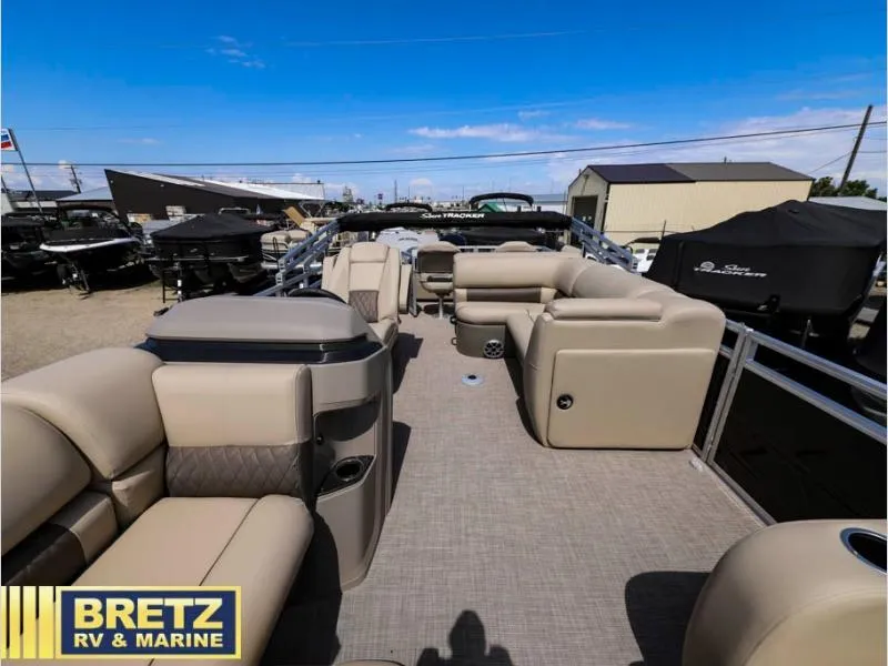 Slide: The Image of 2024 Sportfish 22 DLX pontoon boat interior with beige seating at Bretz RV & Marine. - 17