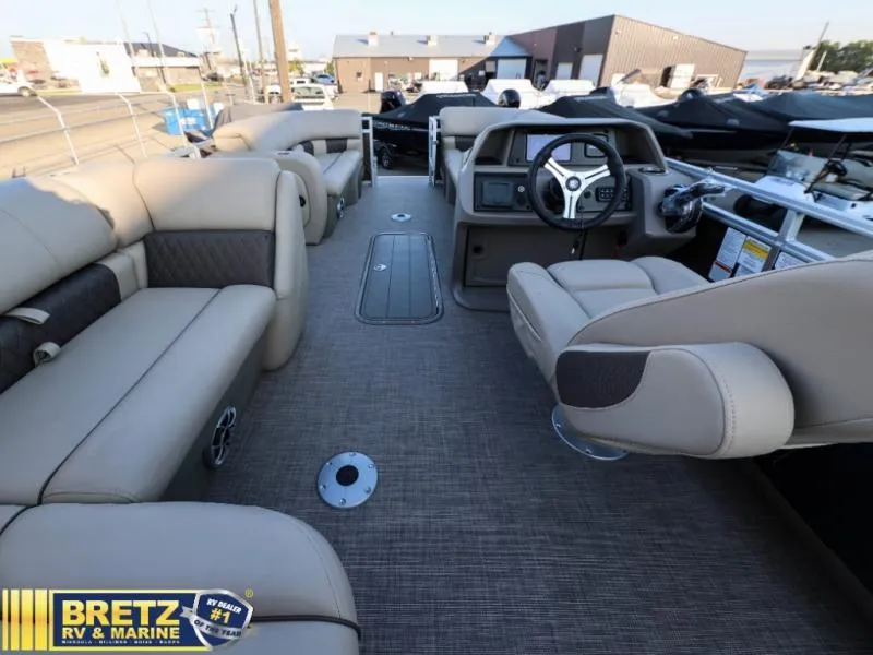 Slide: The Image of Interior of 2024 Sportfish 22 XP3 pontoon boat with beige seating and modern dashboard. - 24