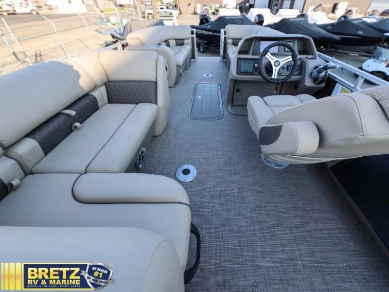 Slide: The Image of Interior of 2024 Sportfish 22 XP3 pontoon boat with beige seating and modern dashboard. - 25