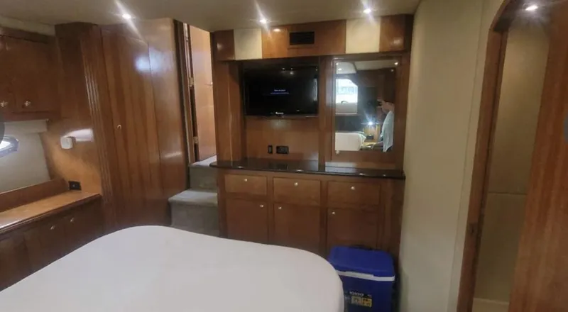 Slide: The Image of Luxurious 2005 Cruisers Yachts 405 Express Motoryacht interior with wood cabinetry and modern amenities. - 15