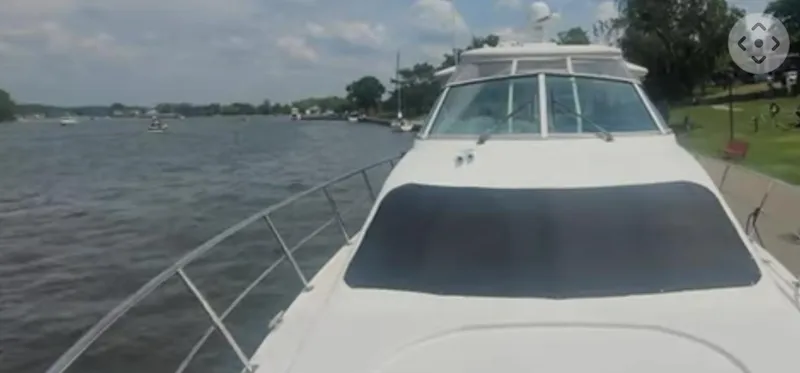 Slide: The Image of 2005 Cruisers Yachts 405 Express Motoryacht on a scenic river. - 2