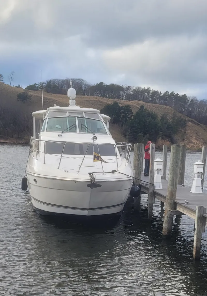 Slide: The Image of 2005 Cruisers Yachts 405 Express Motoryacht docked on a calm lake. - 5