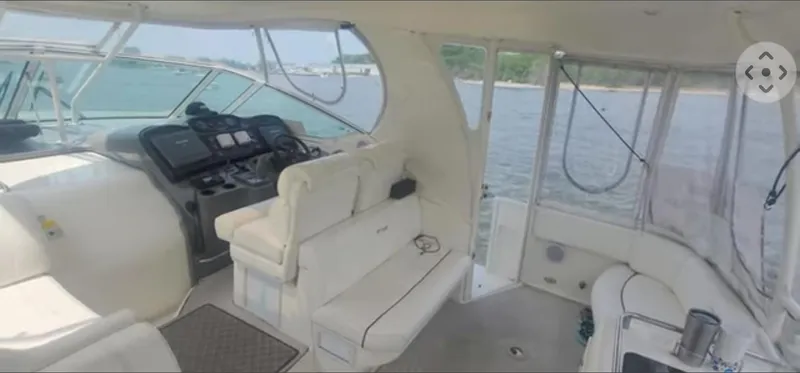 Slide: The Image of 2005 Cruisers Yachts 405 Express Motoryacht interior with helm and seating, overlooking water. - 7