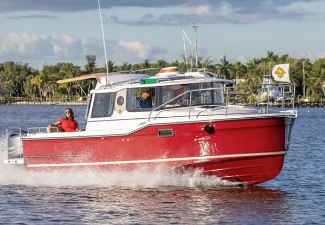 Slide: The Image of 2020 Ranger Tugs 25 cruising on a sunny day with palm trees in the background. - 0