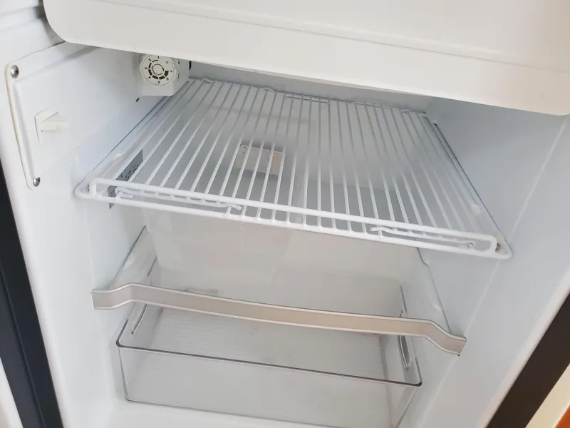 Slide: The Image of Empty refrigerator interior in a 2020 Ranger Tugs 25 boat. - 11