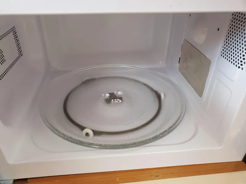 Slide: The Image of Empty microwave interior with glass turntable, viewed from the front. - 12